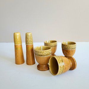 Mid Century 4 teak and ceramic egg cups with matching salt and pepper shakers.